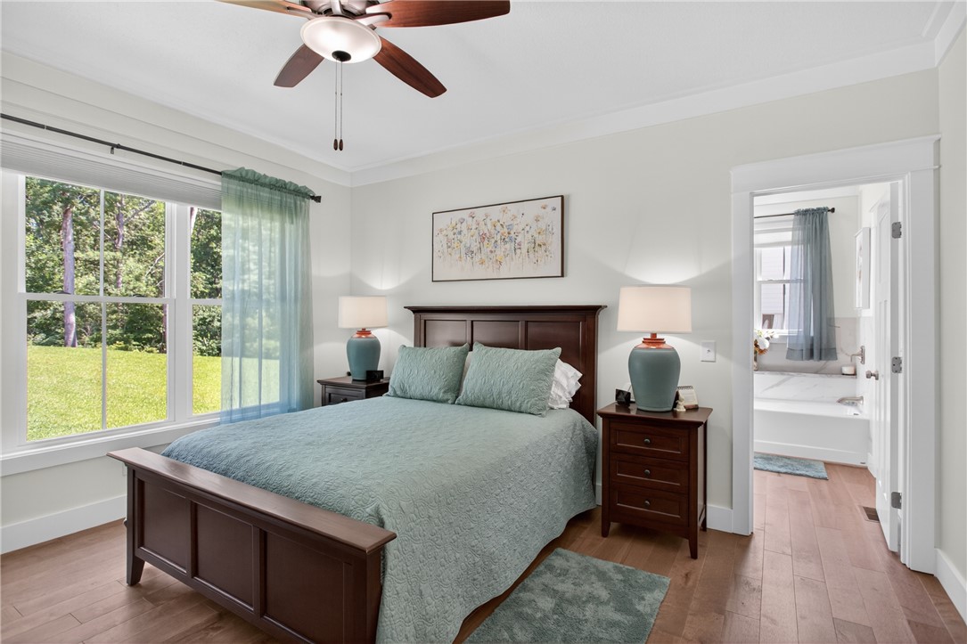 921 Falling Waters Lane Seneca, SC 29672 - Photo 21 of 46 Hardwood floors and a tranquil outdoor view define this comforting bedroom suite.