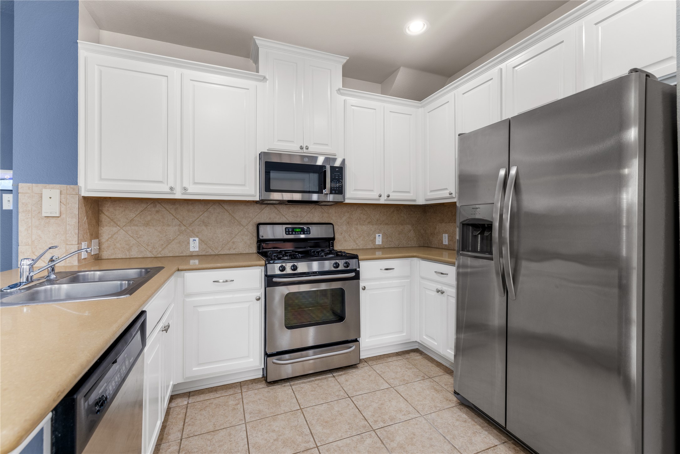11000 Anderson Mill Road, Unit 45 Austin, TX 78750 - Photo 8 of 32 a kitchen with stainless steel appliances granite countertop a sink a stove a refrigerator and cabinets