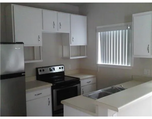 a kitchen with cabinets and appliances