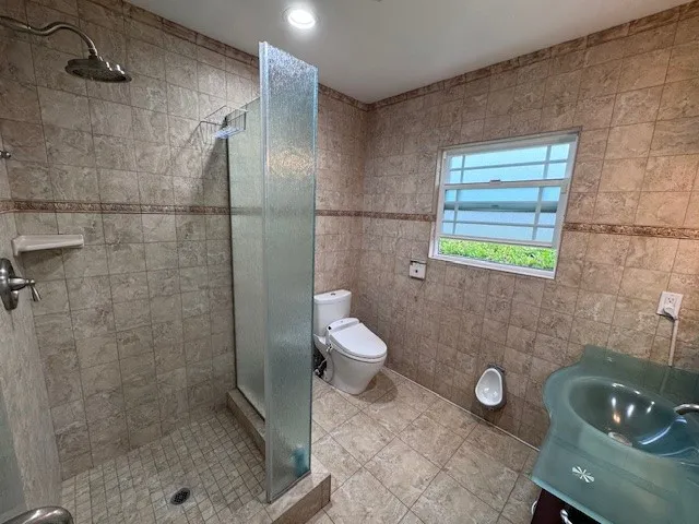 a bathroom with a sink a toilet and a shower