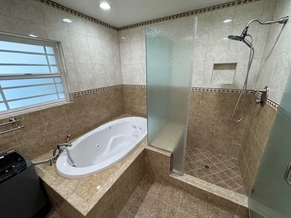 a bathroom with a granite countertop sink a mirror and shower