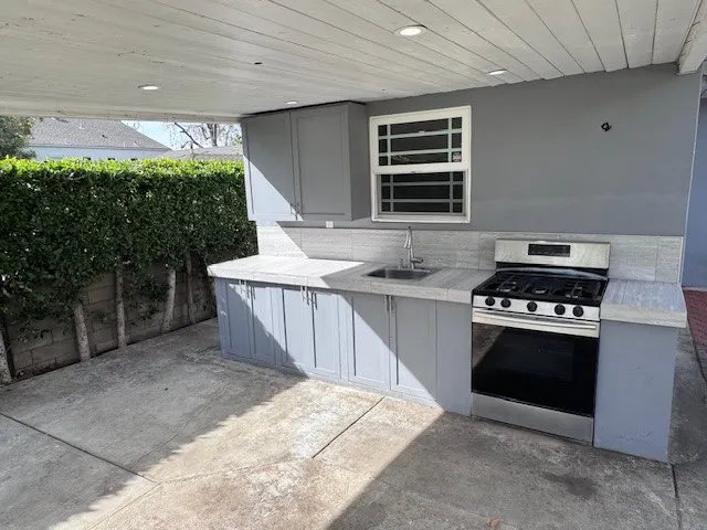 a kitchen with stainless steel appliances a stove a sink and a microwave