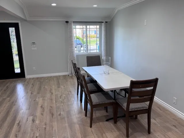 a view of a dining room with furniture and wooden floor