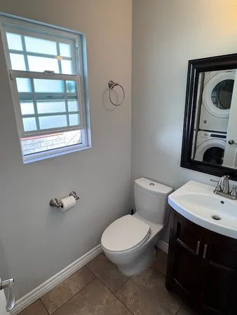 a bathroom with a toilet sink and mirror