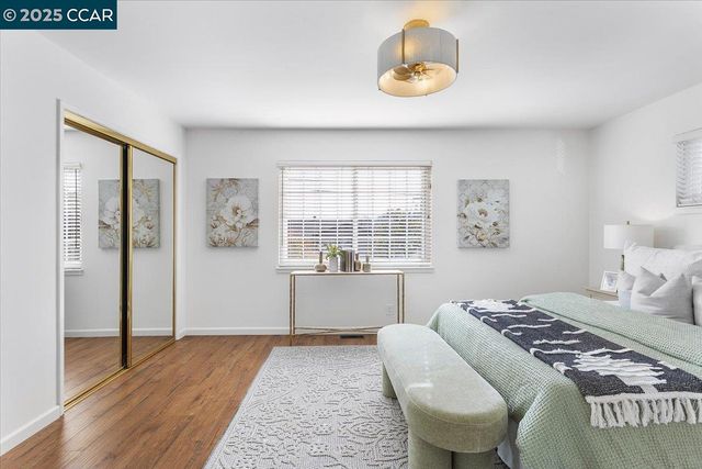 a spacious bedroom with a bed and a window