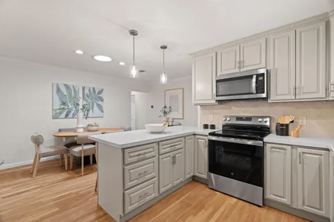 a kitchen with a sink stove and cabinets