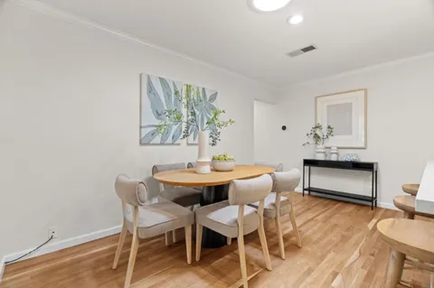 a dining room with furniture and wooden floor