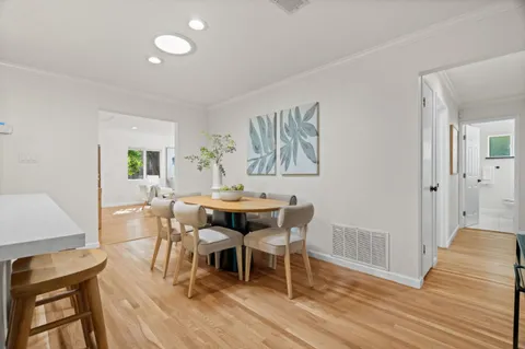a view of a dining room with furniture and wooden floor