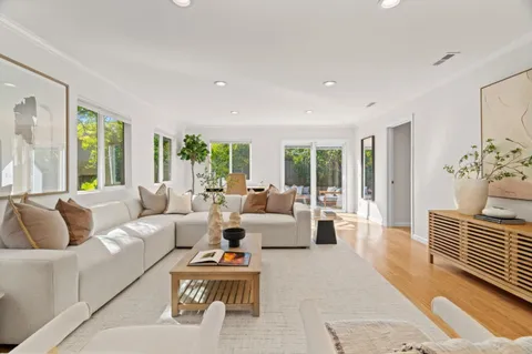 a living room with furniture and large windows