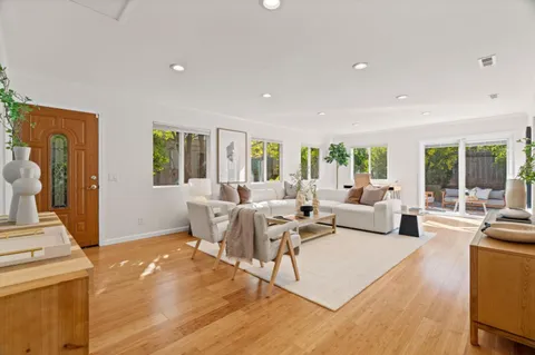 a living room with fireplace furniture and a large window