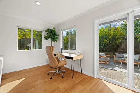 a workspace with wooden floor and a window