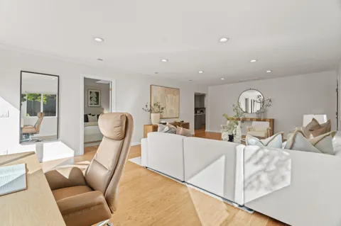 a living room with furniture a table and chairs