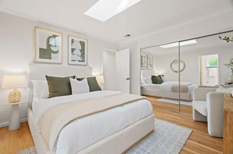 a bedroom with bed and a night stand