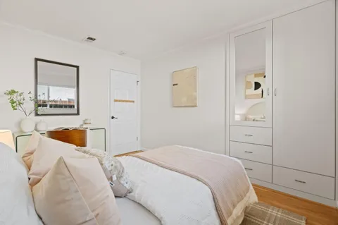 a bedroom with a bed and a couch