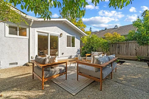 a house view with a sitting space and garden
