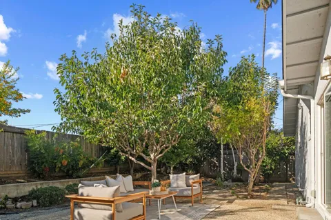 an aerial view of a house with a yard and garden