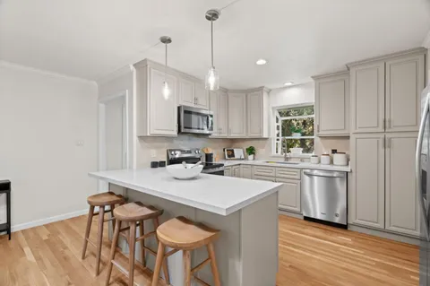 a kitchen with a sink cabinets and window