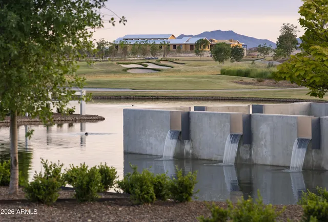 a front view of a house with cars parked