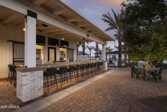 a view of a patio with dining table and chairs with wooden fence