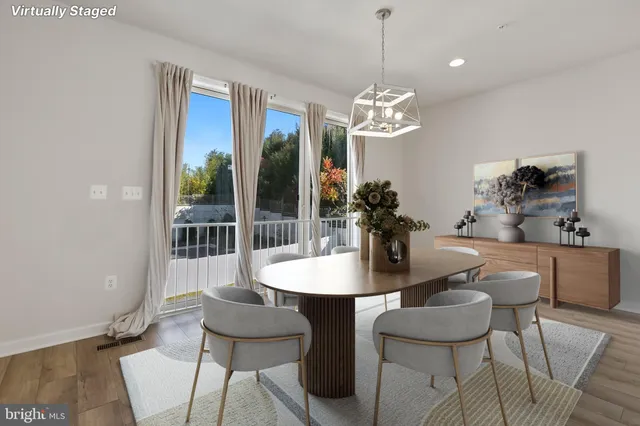 a dining room with furniture a chandelier and window