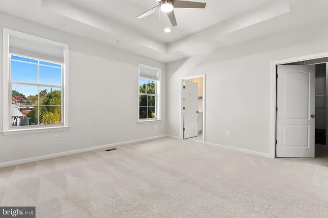 an empty room with windows and closet