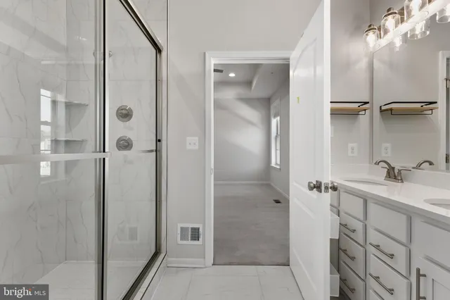 a bathroom with a shower sink and mirror