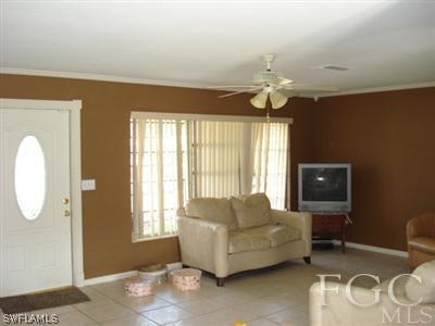 308 East Jersey Road Lehigh Acres, FL 33936 - Photo 3 of 10 a living room with furniture and a large window
