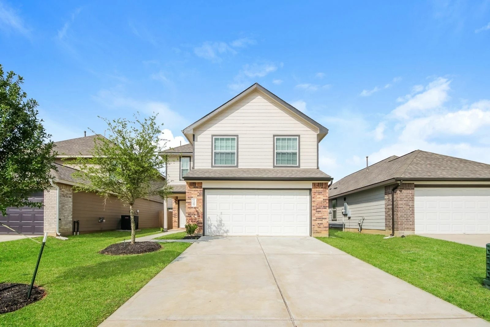 1208 Narrow Heights Drive Conroe, TX 77301 - Photo 1 of 21 a front view of a house with a yard and garage