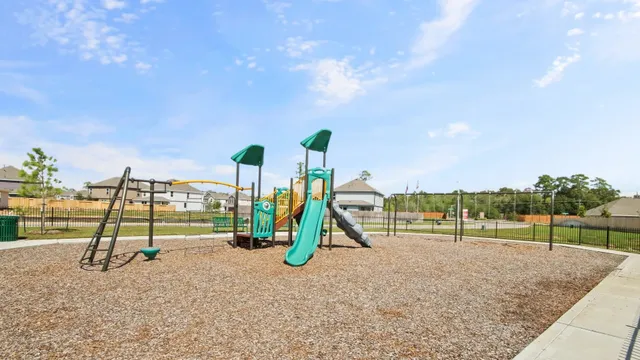 a view of outdoor space with playground and green space
