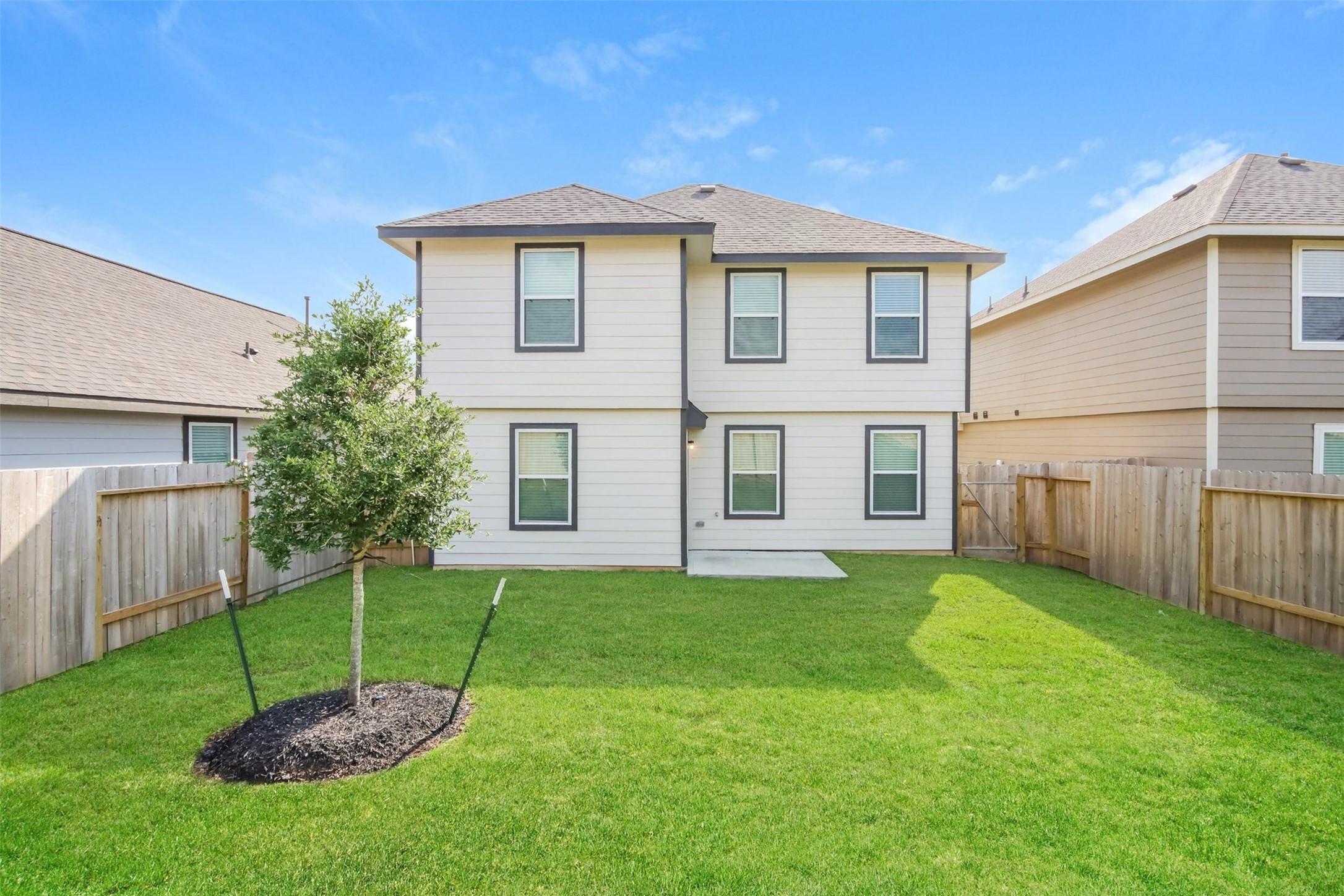 1208 Narrow Heights Drive Conroe, TX 77301 - Photo 2 of 21 a white house with a small yard and a large tree