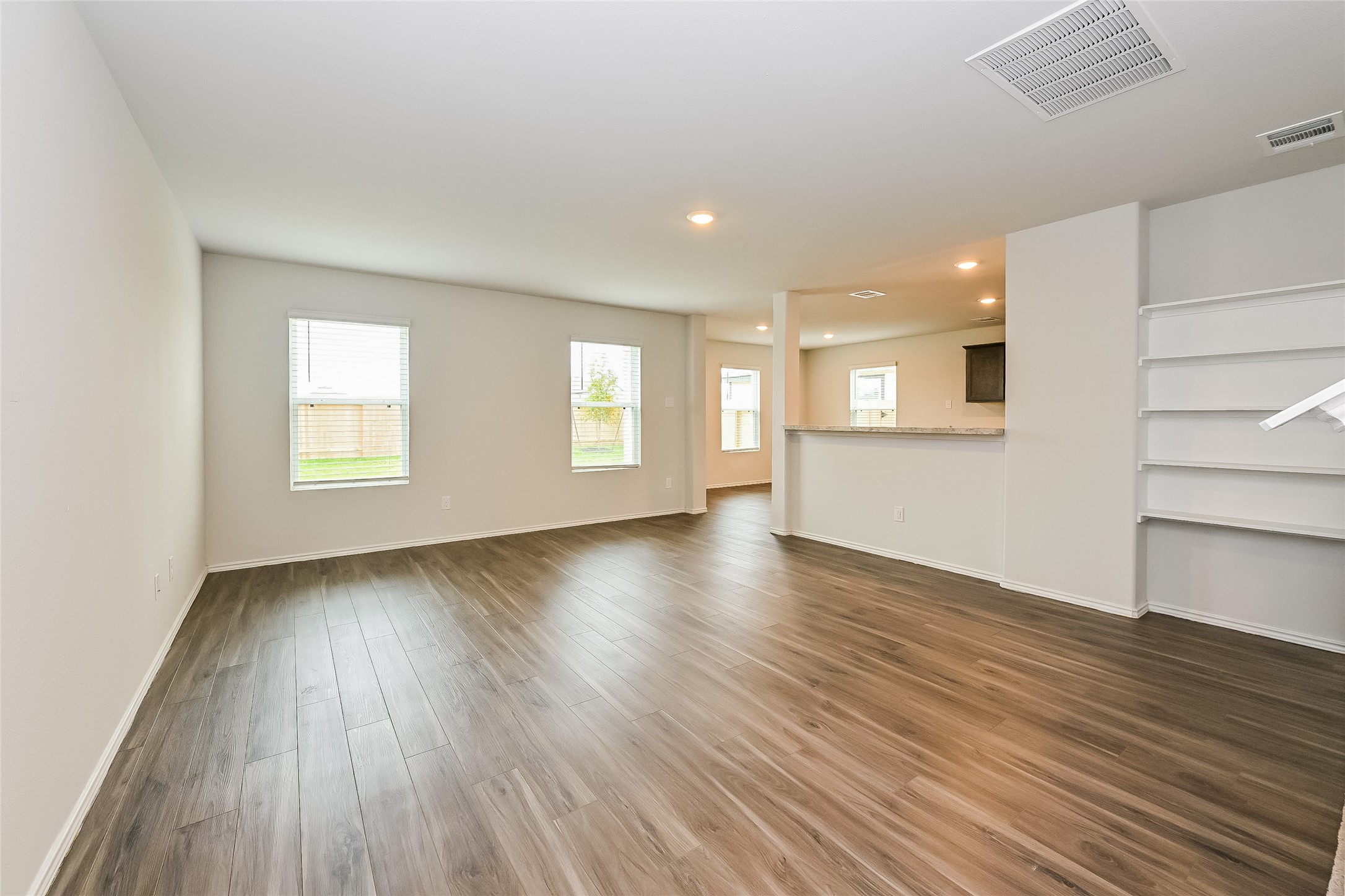 1208 Narrow Heights Drive Conroe, TX 77301 - Photo 7 of 21 an empty room with wooden floor and windows