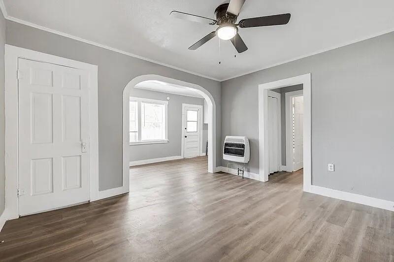 216 East Division Street Pilot Point, TX 76258 - Photo 4 of 17 Living area featuring wood-finish flooring, light gray wall paint, and white trim