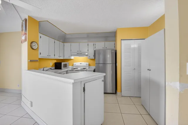 a kitchen with a refrigerator and a sink