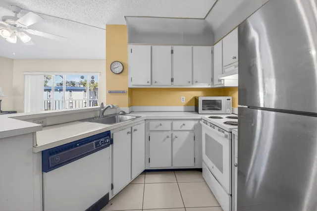 a kitchen with a sink stove and refrigerator
