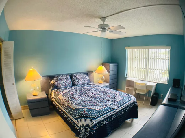 a bedroom with a bed window and couch