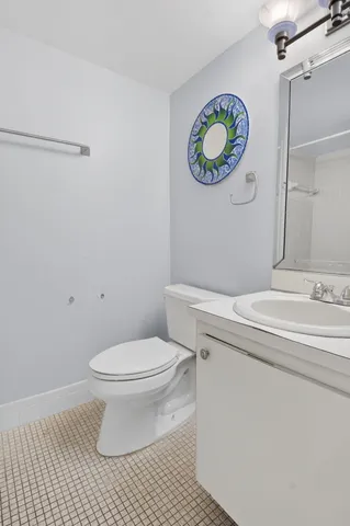 a bathroom with a sink toilet and a mirror