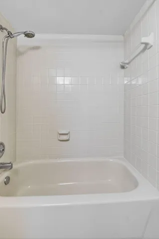 a bathroom with a shower and a bath tub