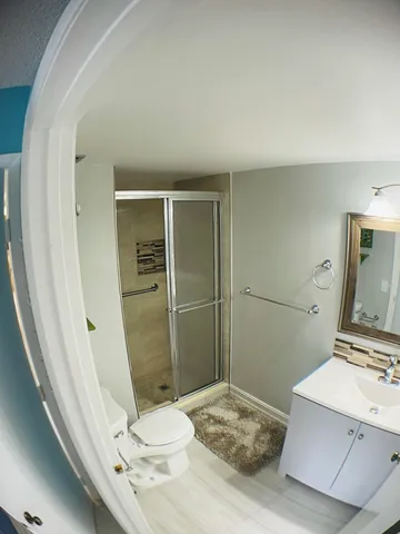 a bathroom with a sink a toilet and shower
