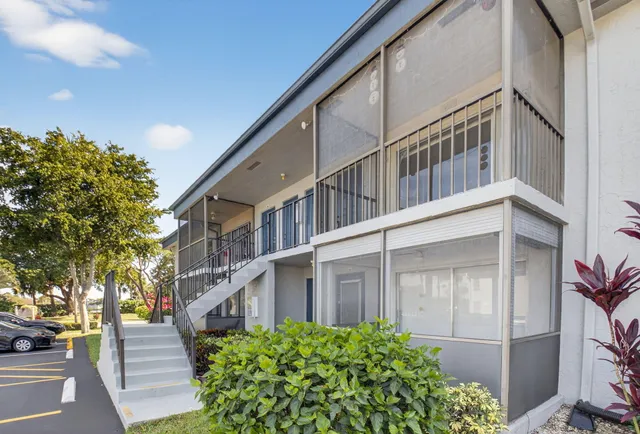 a view of a large building with a large window and potted plants