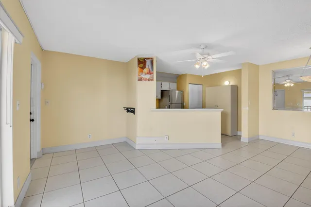 a view of a kitchen with a sink and a refrigerator