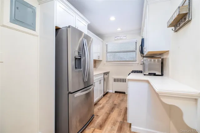 a kitchen with a refrigerator a stove top oven a washer dryer and a refrigerator