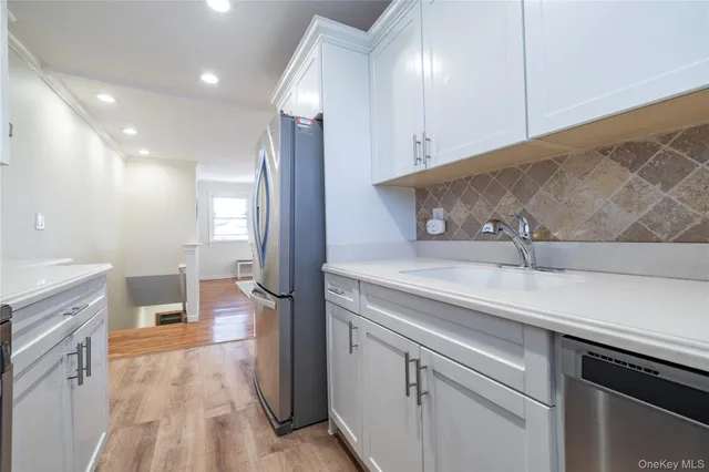 a kitchen with a sink and refrigerator