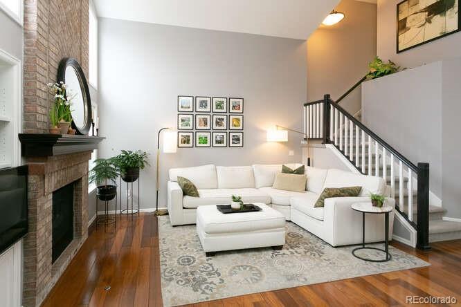 9772 Quay Loop Westminster, CO 80021 - Photo 11 of 36 a living room with furniture and a fireplace