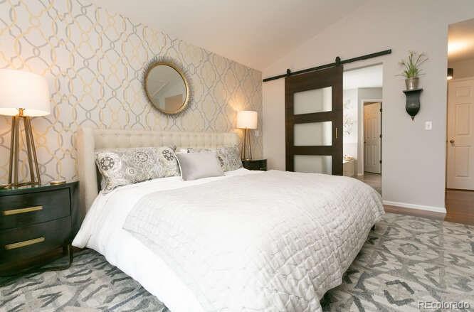 9772 Quay Loop Westminster, CO 80021 - Photo 14 of 36 a bedroom with a bed and a painting on the wall