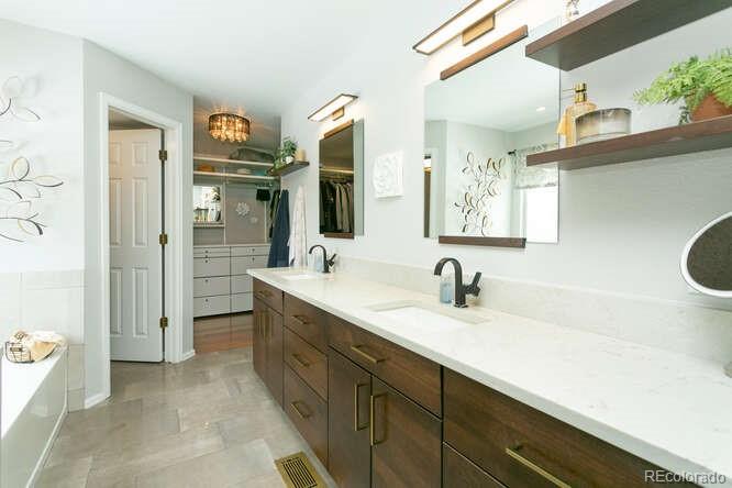 9772 Quay Loop Westminster, CO 80021 - Photo 15 of 36 a bathroom with a sink a toilet and shower