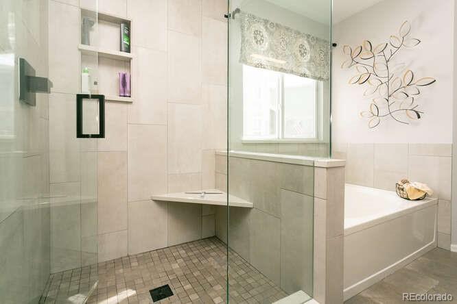9772 Quay Loop Westminster, CO 80021 - Photo 16 of 36 a bathroom with a bathtub and shower