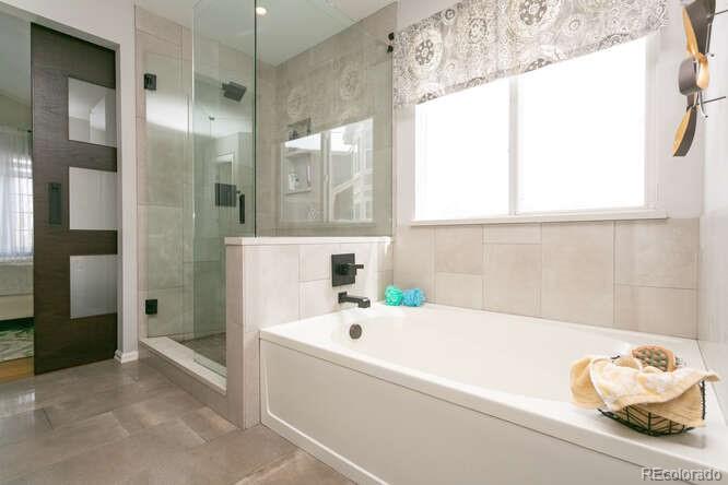 9772 Quay Loop Westminster, CO 80021 - Photo 17 of 36 a bathroom with a tub sink and shower