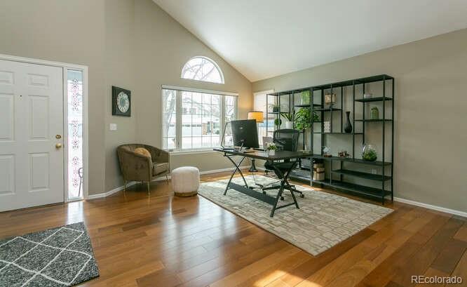 9772 Quay Loop Westminster, CO 80021 - Photo 2 of 36 a living room filled with furniture hardwood floor and a table