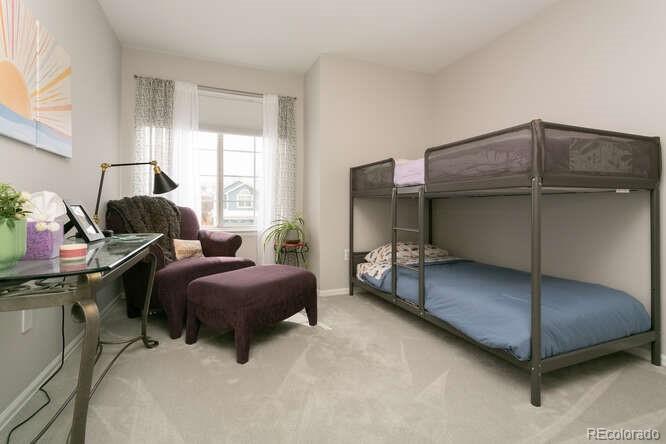 9772 Quay Loop Westminster, CO 80021 - Photo 21 of 36 a bedroom with bed and a window