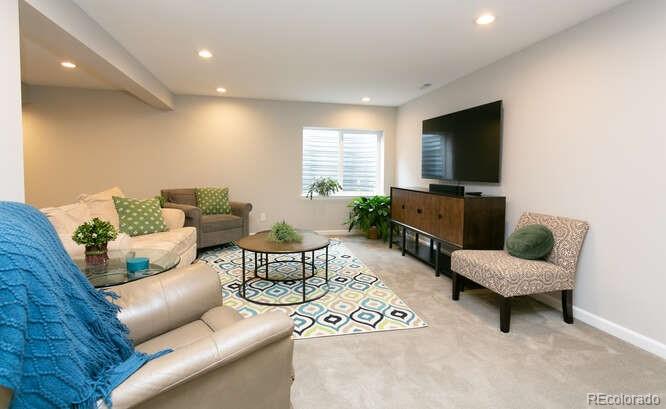 9772 Quay Loop Westminster, CO 80021 - Photo 24 of 36 a living room with furniture and a flat screen tv
